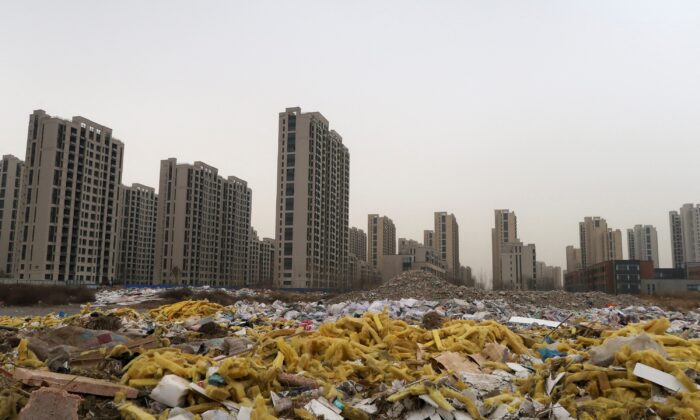 Debris can be seen in front of Tao Yuan Singh Du Kongechen, an apartment complex developed by China Fortuneland Development in Qiaoxi District, Hebei Province, China on March 19, 2021.  (LushaZhang / Reuters)
