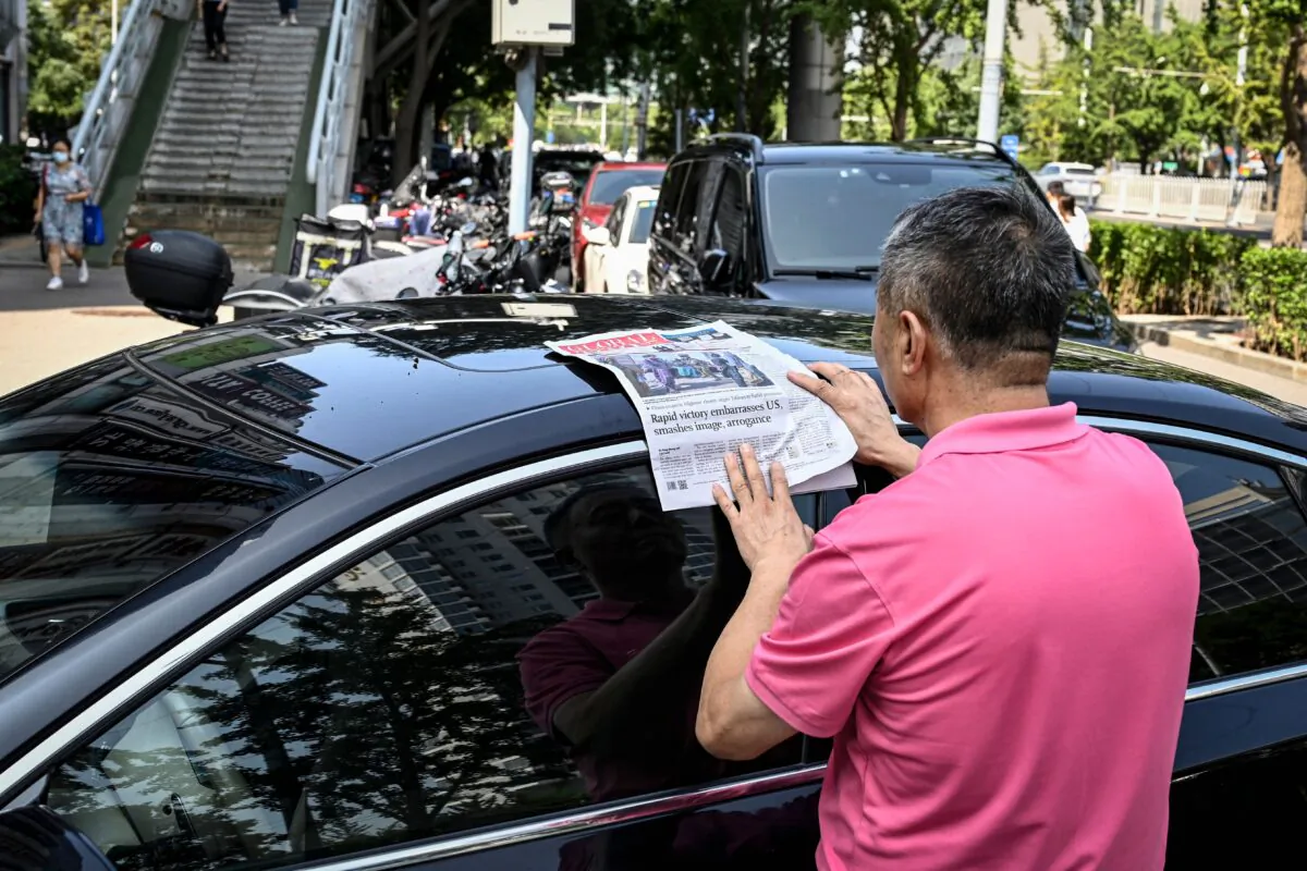 A man reads the Chinese state-run newspaper Global Times on a street in Beijing, China on Aug. 17, 2021. (Jade Gao/AFP via Getty Images)