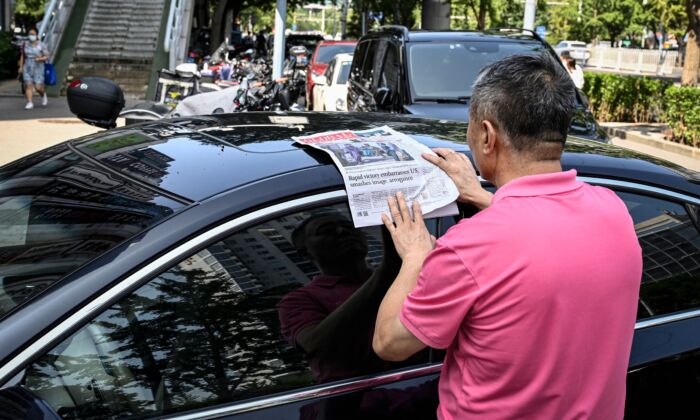 A man reads the Chinese state-run newspaper Global Times on a street in Beijing, China on Aug. 17, 2021. (Jade Gao/AFP via Getty Images)