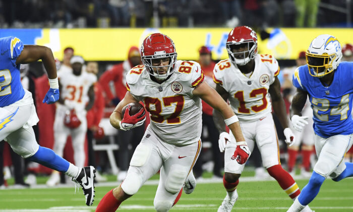 Travis Kelce #87 of the Kansas City Chiefs carries the ball for a touchdown during overtime against the Los Angeles Chargers at SoFi Stadium in Inglewood, Calif., on Dec. 16, 2021.  (Kevork Djansezian/Getty Images)