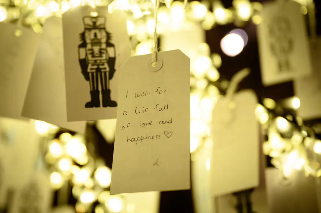Handwritten Christmas wishes hang from a Christmas tree as a part of in Woodstock, England, on Nov. 18, 2021. (Leon Neal/Getty Images)