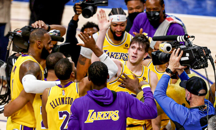 Austin Reaves #15 of the Los Angeles Lakers reacts after shooting the game-winning shot against Tim Hardaway Jr. #11 of the Dallas Mavericks in overtime at American Airlines Center, in Dallas, on Dec. 15, 2021. (Tom Pennington/Getty Images)