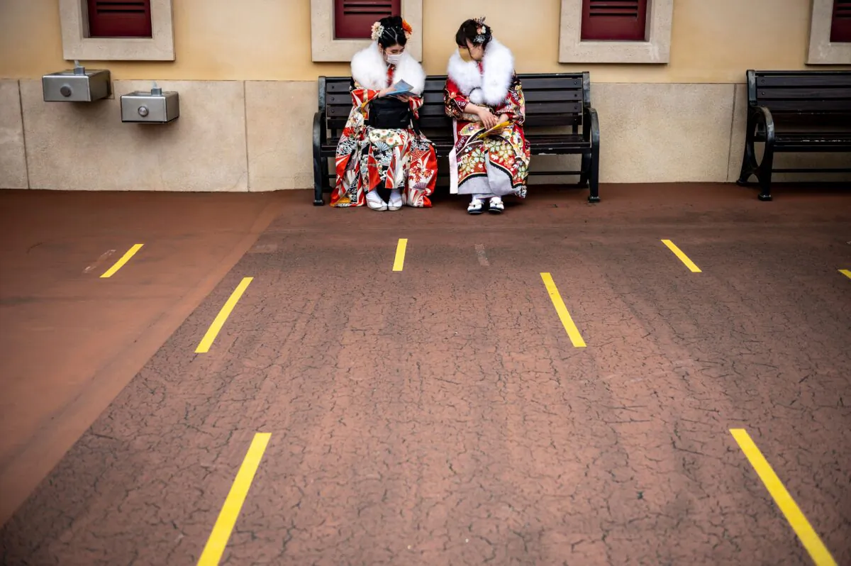 Twenty-year-old women wearing kimonos wait to attend a postponed "Coming-of-Age Day" celebration ceremony, due to the COVID-19 pandemic, at DisneySea in Urayasu, Japan, on March 7, 2021. (Philip Fong/AFP via Getty Images)