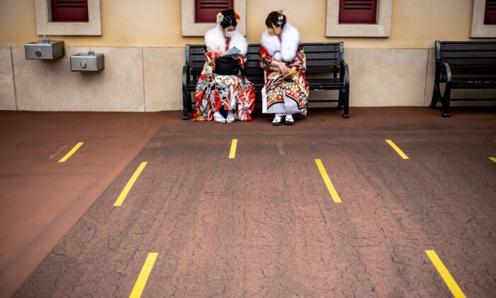 Twenty-year-old women wearing kimonos wait to attend a postponed "Coming-of-Age Day" celebration ceremony, due to the COVID-19 pandemic, at DisneySea in Urayasu, Japan, on March 7, 2021. (Philip Fong/AFP via Getty Images)