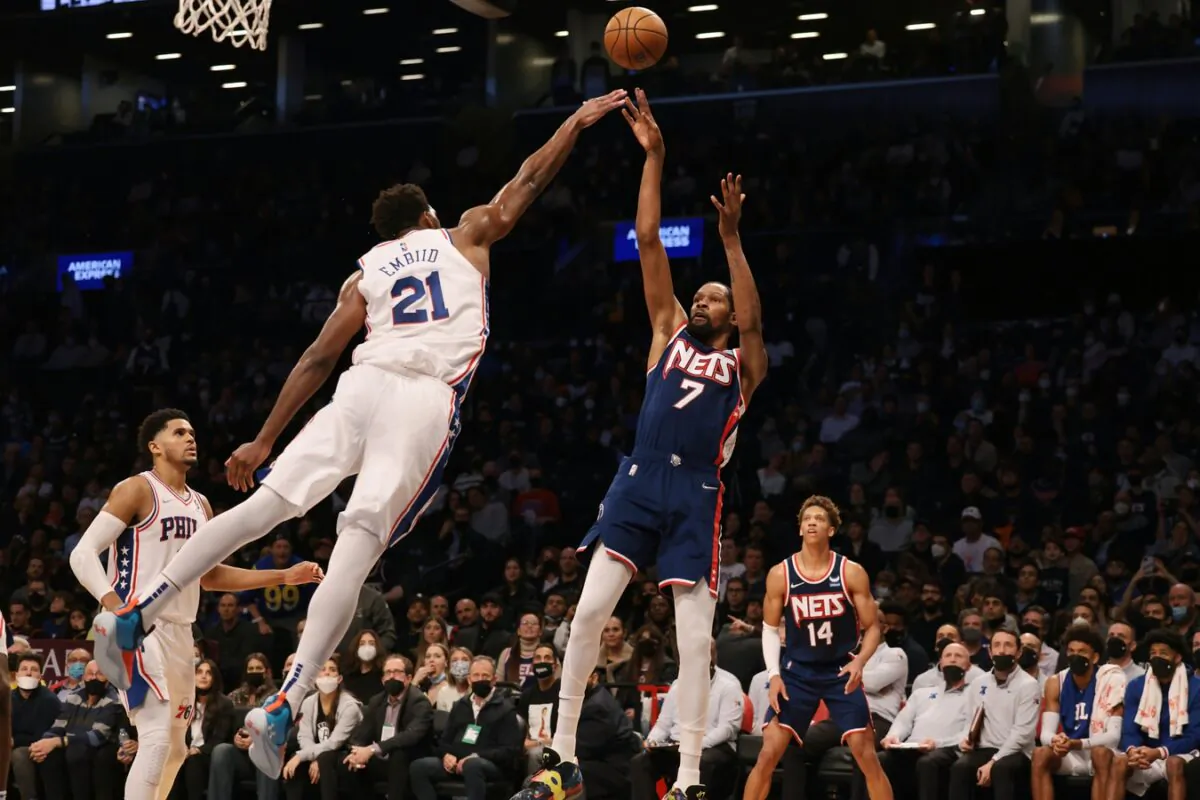 Brooklyn Nets forward Kevin Durant (7) shoots the ball as Philadelphia 76ers center Joel Embiid (21) defends during the second half at Barclays Center in Brooklyn, New York, on Dec. 16, 2021. (Vincent Carchietta-USA TODAY Sports via Field Level Media)