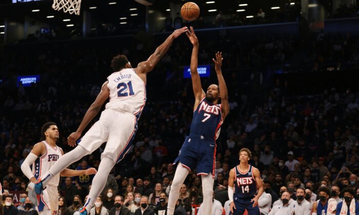 Brooklyn Nets forward Kevin Durant (7) shoots the ball as Philadelphia 76ers center Joel Embiid (21) defends during the second half at Barclays Center in Brooklyn, New York, on Dec. 16, 2021. (Vincent Carchietta-USA TODAY Sports via Field Level Media)