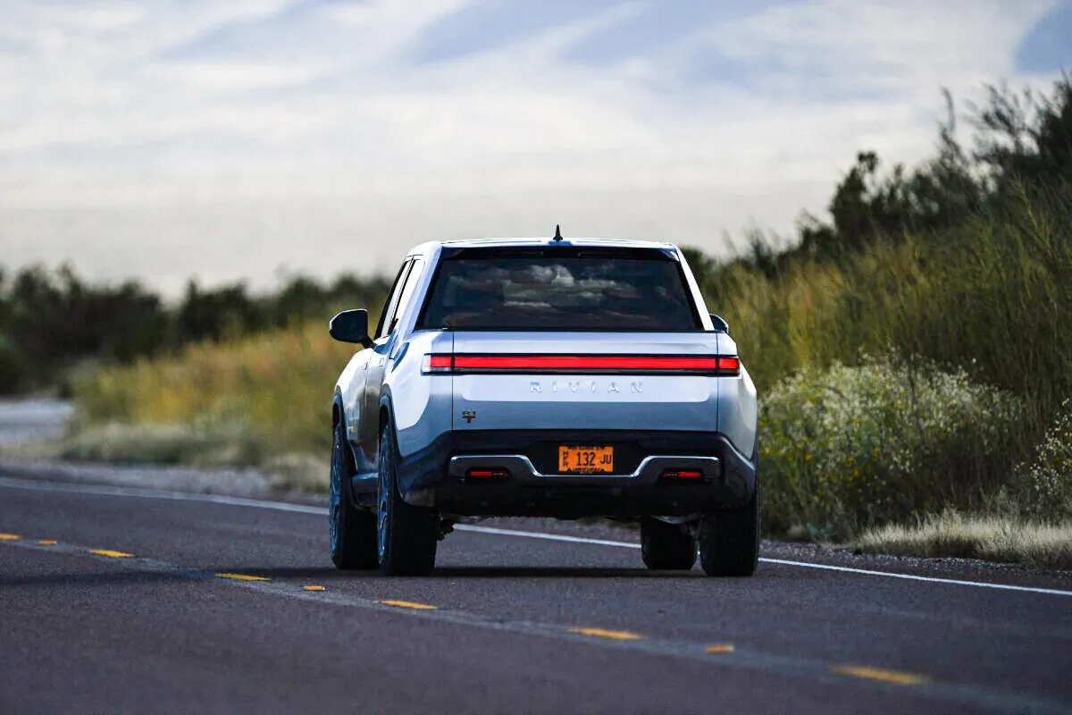 A Rivian R1T electric truck drives down a highway near the entrance to Blue Origin's Launch Site One outside of Van Horn, Texas, on Oct. 12, 2021. (Patrick T. Fallon/AFP via Getty Images)