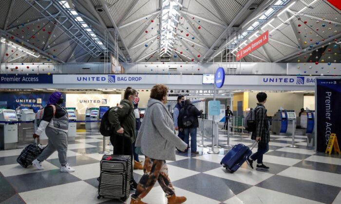 Travelers pass through O'Hare International Airport in Chicago, Ill., on Nov. 25, 2020. (Kamil Krzaczynski/Reuters)