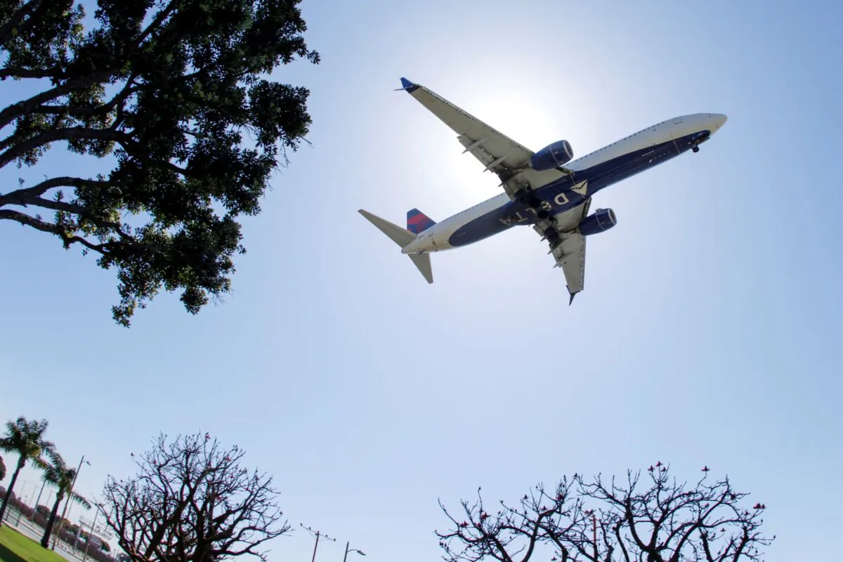 A Delta Airlines passenger jet approaches to land at LAX in Los Angeles, Calif., on April 7, 2021. (Mike Blake/Reuters)