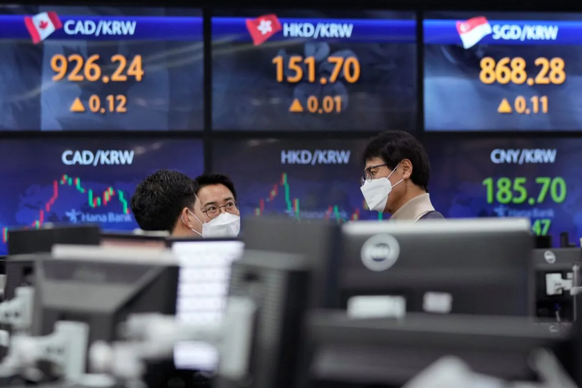 Currency traders talk to each other at the foreign exchange dealing room of the KEB Hana Bank headquarters in Seoul, South Korea, on Dec. 17, 2021. (Ahn Young-joon/AP Photo)