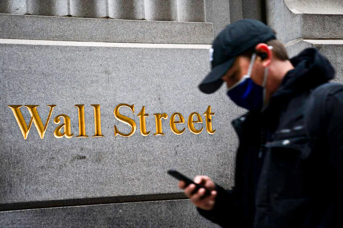 A pedestrian passes the New York Stock Exchange on Nov. 30, 2021. (John Minchillo/AP Photo)