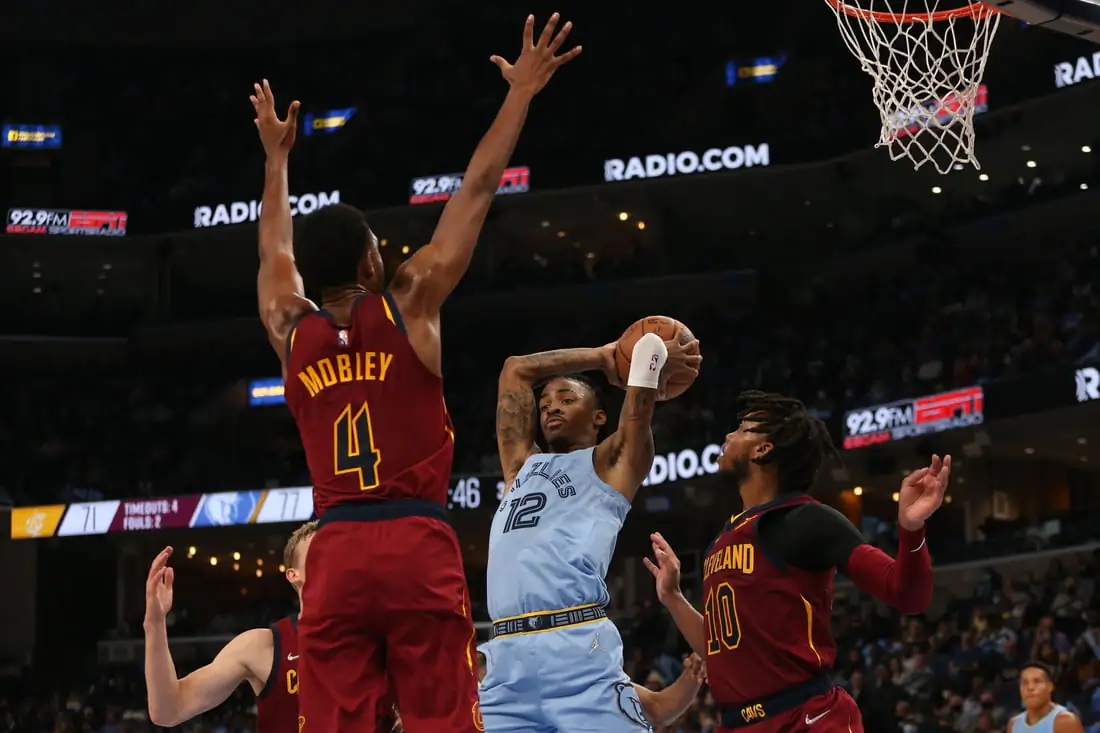 Memphis Grizzles guard Ja Morant (12) passes the ball as Cleveland Cavaliers center Evan Mobley (4) and  guard Darius Garland (10) defend during the second half at FedExForum in Memphis, Tenn., on Oct 20, 2021. (Petre Thomas/USA TODAY Sports Via Field Level Media)
