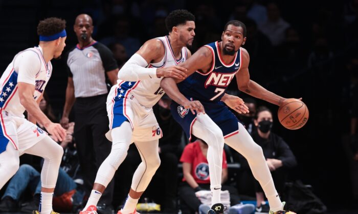 Brooklyn Nets forward Kevin Durant (7) dribbles as Philadelphia 76ers forward Tobias Harris (12) defends during the first half at Barclays Center, Brooklyn, New York on Dec. 16, 2021. (Vincent Carchietta/USA TODAY Sports)
