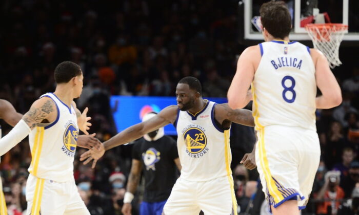 Golden State Warriors forward Draymond Green (23) celebrates with teammates against the Phoenix Suns during the second half at Footprint Center in Phoenix, Ariz., on Dec 25, 2021. (Joe Camporeale/USA TODAY Sports via Field Level Media)