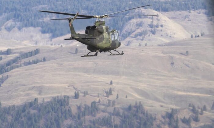 Canadian Forces Griffon helicopters fly over the floods in Princeton, B.C., December 3, 2021. (The Canadian Press/Jonathan Hayward) 