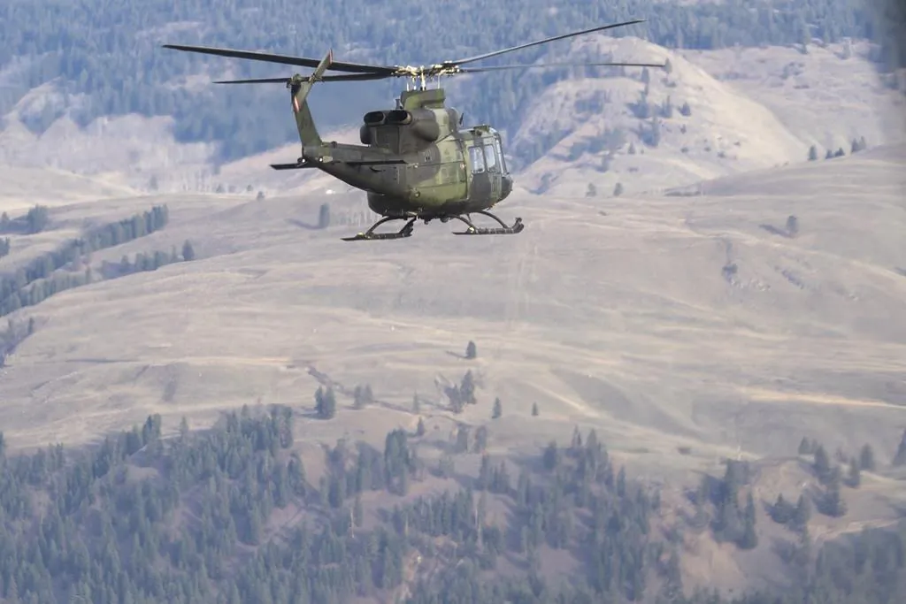 Canadian Forces Griffon helicopters fly over the floods in Princeton, B.C., December 3, 2021. (The Canadian Press/Jonathan Hayward) 