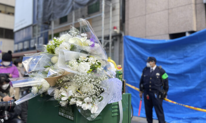 Flowers and drinks are placed in front of a building where a fire broke out Friday in Osaka, western Japan, on Dec. 18, 2021. (Chisato Tanaka/AP Photo)
