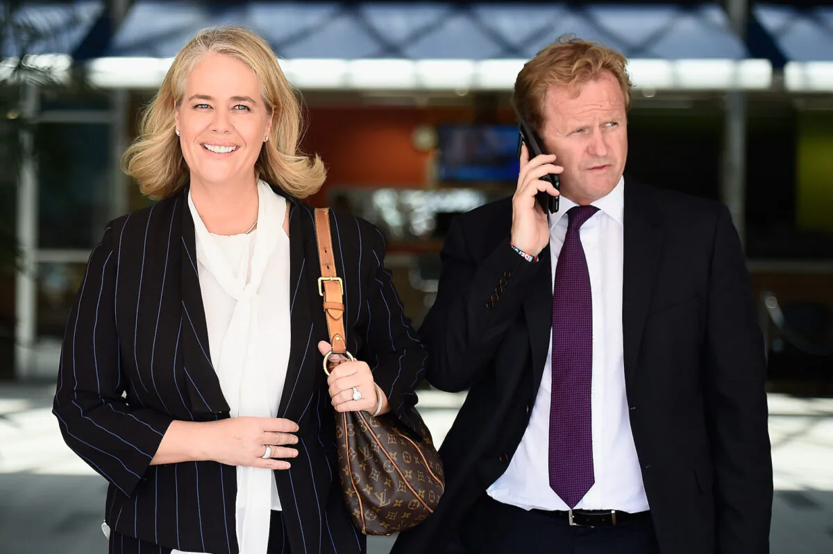 Titans club chairwoman Rebecca Frizelle leaves with NRL Chief Executive Dave Smith after a Gold Coast Titans NRL press conference at the Titans Headquarters on the Gold Coast, Australia, on Feb. 24, 2015. (Matt Roberts/Getty Images)