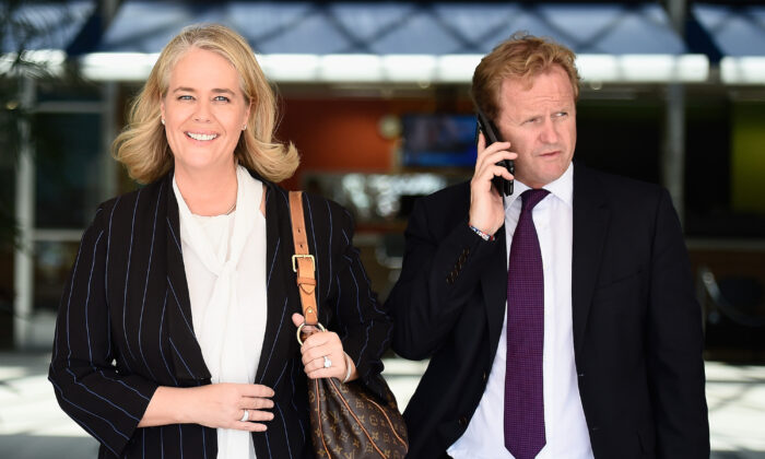 Titans club chairwoman Rebecca Frizelle leaves with NRL Chief Executive Dave Smith after a Gold Coast Titans NRL press conference at the Titans Headquarters on the Gold Coast, Australia, on Feb. 24, 2015. (Matt Roberts/Getty Images)