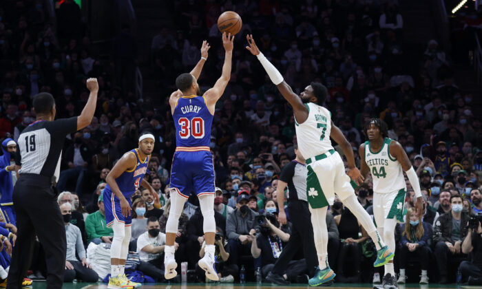 Golden State Warriors guard Stephen Curry (30) shoots a three-point basket over Boston Celtics guard Jaylen Brown (7) during an NBA game in Boston, Mass., on Dec. 17, 2021. (Mary Schwalm/AP Photo)
