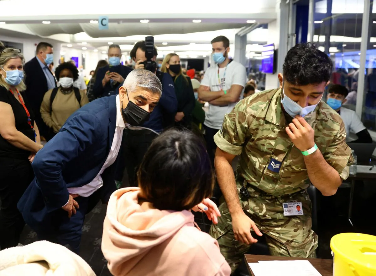 Mayor of London Sadiq Khan (L) visits a coronavirus disease (COVID-19) pop-up vaccination centre at Chelsea football ground, Stamford Bridge in London, Britain, on Dec. 18, 2021. (David Klein/Reuters)