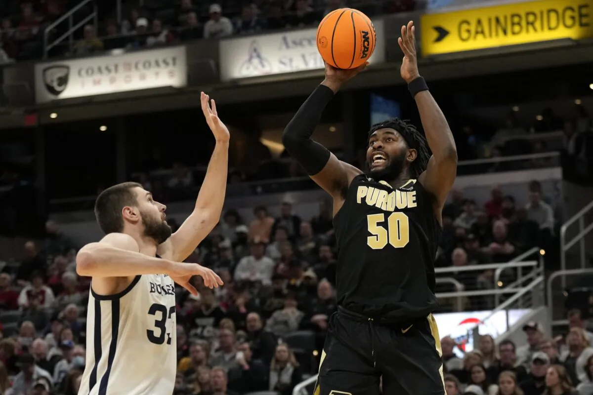 Purdue forward Trevion Williams (50) shoots over Butler forward Bryce Golden, during an NCAA college basketball game in Ind., on Dec. 18, 2021. (AJ Mast/AP Photo)