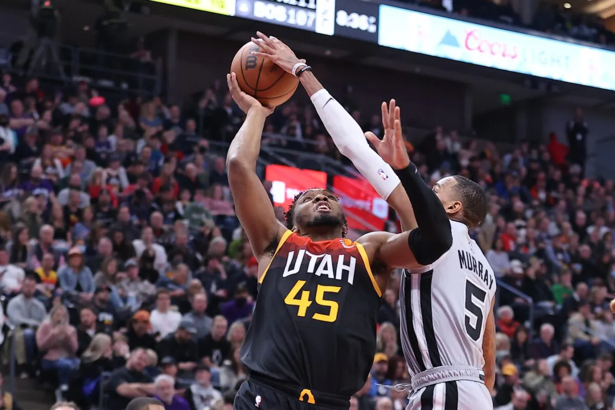 San Antonio Spurs guard Dejounte Murray (5) blocks the shot of Utah Jazz guard Donovan Mitchell (45) during an NBA game at Vivint Arena, in Salt Lake City, Utah, on Dec. 17, 2021. (Rob Gray/USA TODAY Sports via Field Level Media)