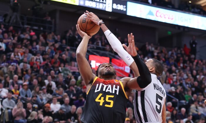 San Antonio Spurs guard Dejounte Murray (5) blocks the shot of Utah Jazz guard Donovan Mitchell (45) during an NBA game at Vivint Arena, in Salt Lake City, Utah, on Dec. 17, 2021. (Rob Gray/USA TODAY Sports via Field Level Media)
