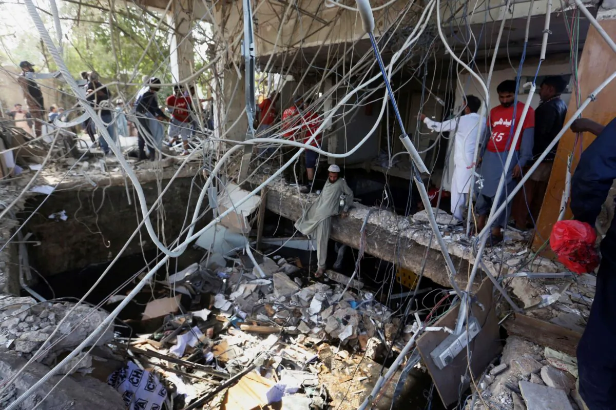Rescuers inspect the scene of a gas explosion in Karachi, Pakistan, on Dec. 18, 2021. (Fareed Khan/AP Photo)
