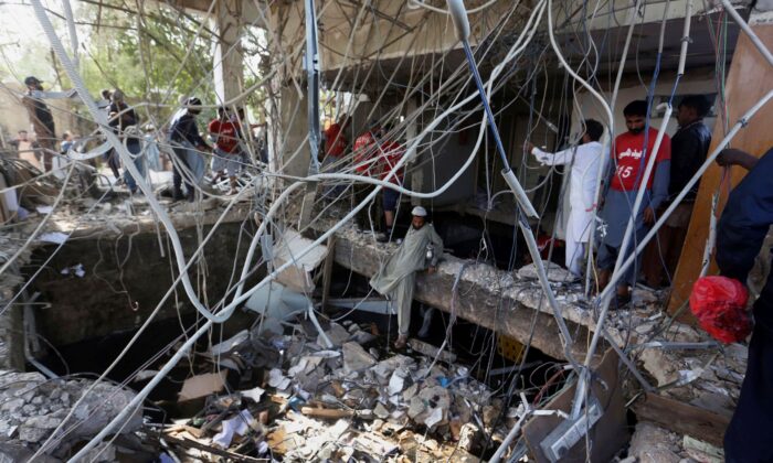 Rescuers inspect the scene of a gas explosion in Karachi, Pakistan, on Dec. 18, 2021. (Fareed Khan/AP Photo)