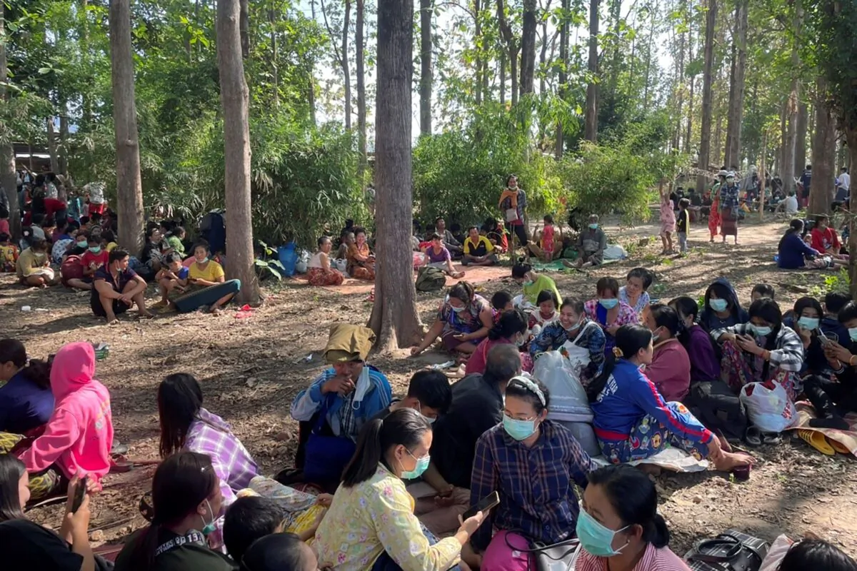 Burma villagers rest in an evacuation area after fleeing to Thailand following clashes between Burma troops and an ethnic Karen rebel group, in Mae Tao, Tak Province, northern Thailand, on Dec. 17, 2021.(Chiraunth Rungjamratratsami/AP Photo)