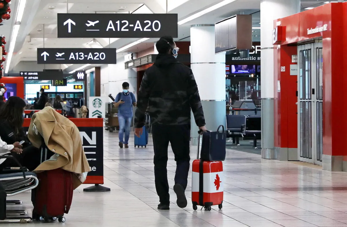Passengers are seen at Toronto Pearson Airport in Toronto on Dec. 3, 2021. (Chris Helgren/Reuters)