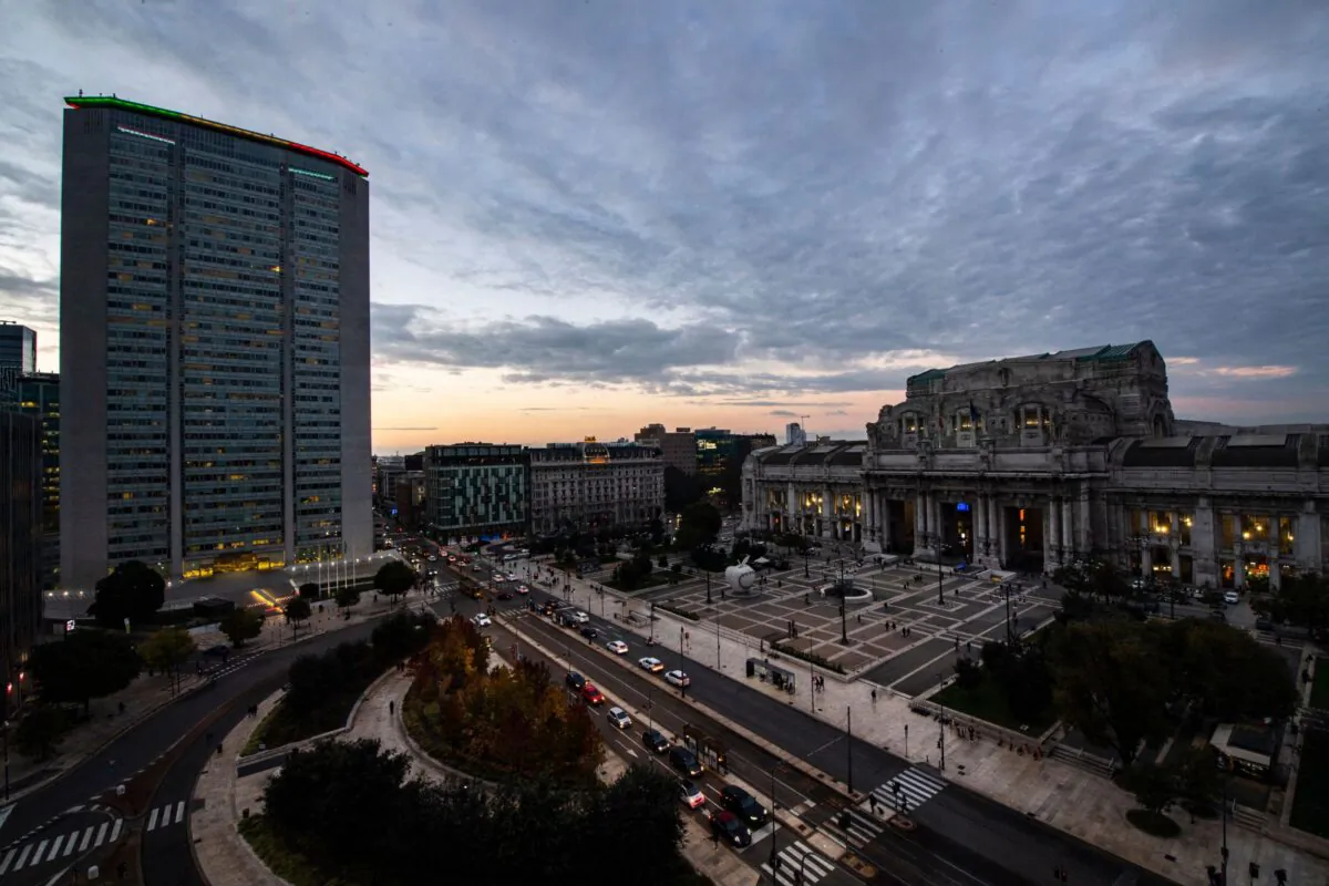 A general view at sunset in central Milan shows the Pirelli building (L), the Milano Centrale railway station (R), and the Piazza Duca D'Aosta, Italy, on Nov. 08, 2021. (Tiziana Fabi/AFP via Getty Images)