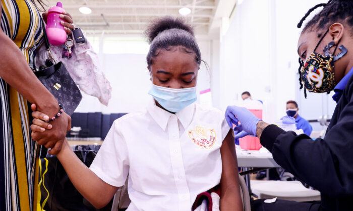 A 13-year-old child receives a COVID-19 vaccination dose at a clinic in New Orleans, La., on Aug. 12, 2021. (Mario Tama/Getty Images)