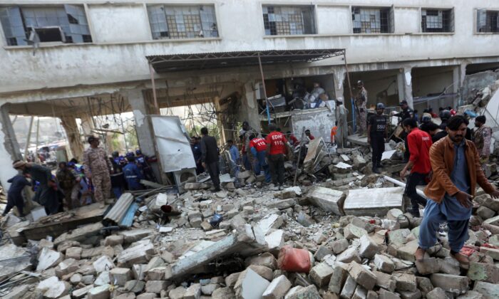 Pakistani security personnel and rescuers inspect the scene of a gas explosion in Karachi, Pakistan, on Dec. 18, 2021. (Fareed Khan/AP Photo)
