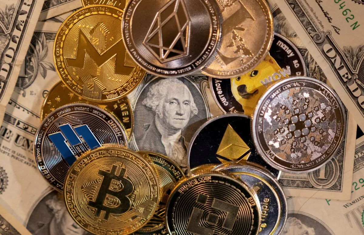 Representations of virtual cryptocurrencies are placed on U.S. Dollar banknotes in this illustration taken on Nov. 28, 2021. (Dado Ruvic/Illustration/Reuters)