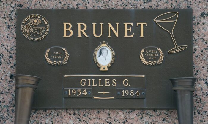 The tombstone of Gilles Brunet in a Montreal cemetery on Dec. 10, 2021.  (The Canadian Press/Paul Chiasson)