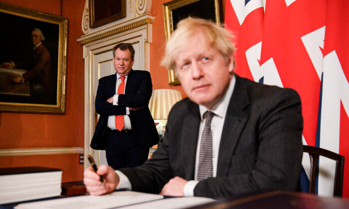 UK chief Brexit negotiator David Frost (L) looks on as Prime Minister Boris Johnson (R) poses for photographs after signing the Brexit trade deal with the EU in number 10 Downing Street in London, on Dec. 30, 2020. (Leon Neal/Getty Images)