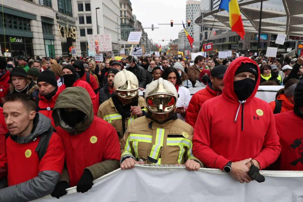 Demonstrators part in a march against recent vaccine mandates imposed in Belgium in Brussels, on Dec. 19, 2021. (NICOLAS MAETERLINCK/Belga/AFP via Getty Images)