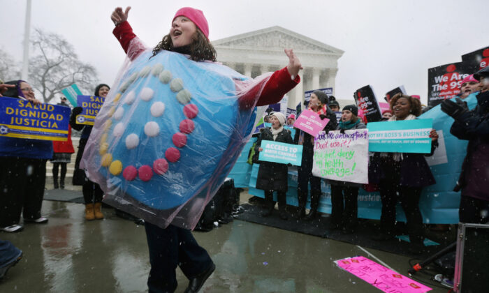 Margot Riphagen of New Orleans dresses as a birth control pill pack while dancing in front of the U.S. Supreme Court during oral arguments in Sebelius v. Hobby Lobby in Washington, DC on March 25, 2014. (Chip Somodevilla/Getty Images)