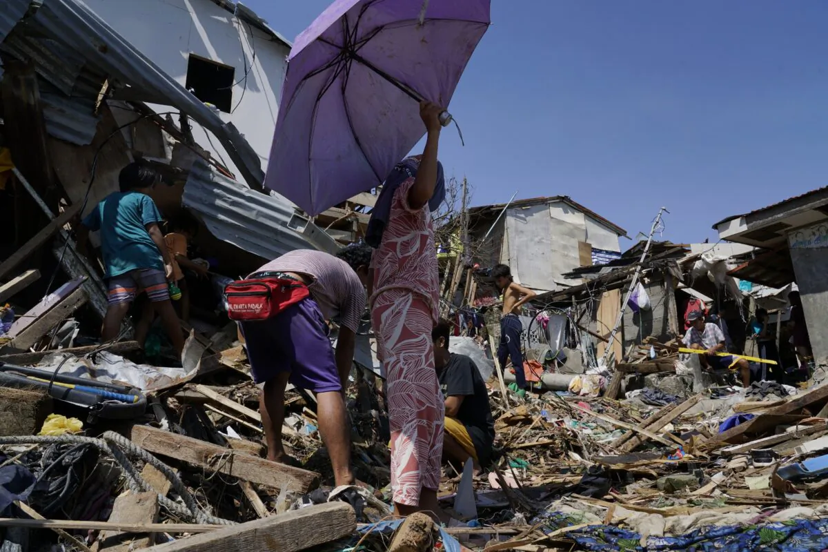 Residents salvage parts of their damaged homes following Typhoon Rai in Talisay, Cebu province, central Philippines, on Dec. 18, 2021. (Jay Labra/AP Photo)