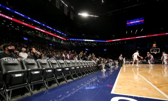General view of mostly empty courtside seats as Orlando Magic forward Franz Wagner (22) controls the ball against the Brooklyn Nets during the first quarter at Barclays Center in Brooklyn, New York, on Dec 18, 2021. (Brad Penner/USA TODAY Sports via Reuters)