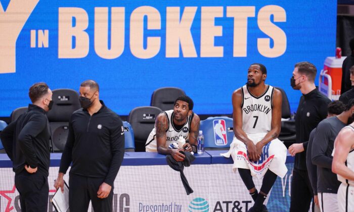 Brooklyn Nets guard Kyrie Irving (11) and forward Kevin Durant (7) rest near the team bench during a timeout against the Golden State Warriors in the fourth quarter at the Chase Center, San Francisco, Calif., on Feb 13, 2021. (Cary Edmondson-USA TODAY Sports)
