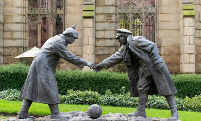 A sculpture in Liverpool, England, depicts a British and a German soldier about to shake hands, commemorating the gesture of peace and goodwill during World War I when soldiers on opposing sides stopped fighting and played soccer together on Christmas Day 1914. (John B Hewitt/Shutterstock)