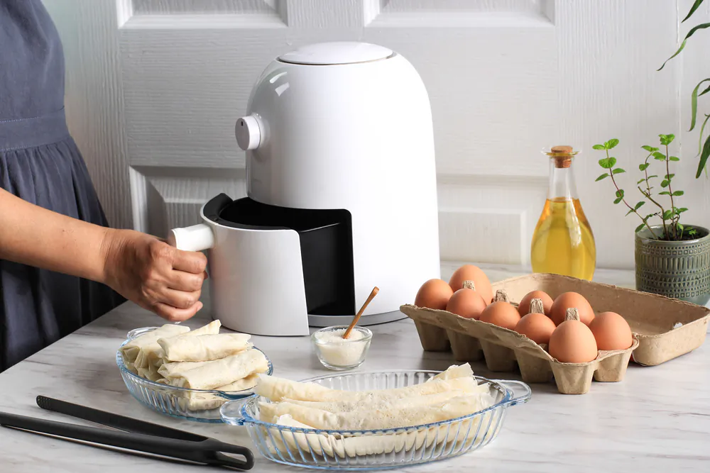 An air fryer is a small countertop convection oven designed to simulate deep-frying without submerging the food in oil. (Ika Rahma H/Shutterstock)