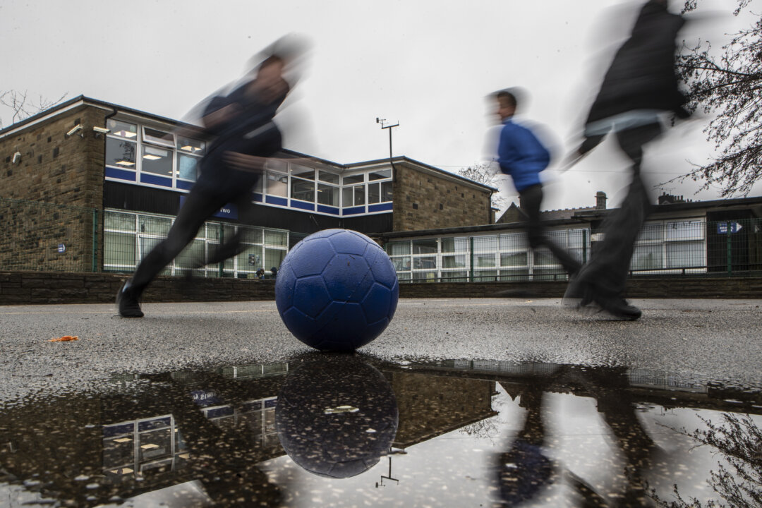 Students play on a playground at a school in the UK in a file photo. (Danny Lawson/PA)