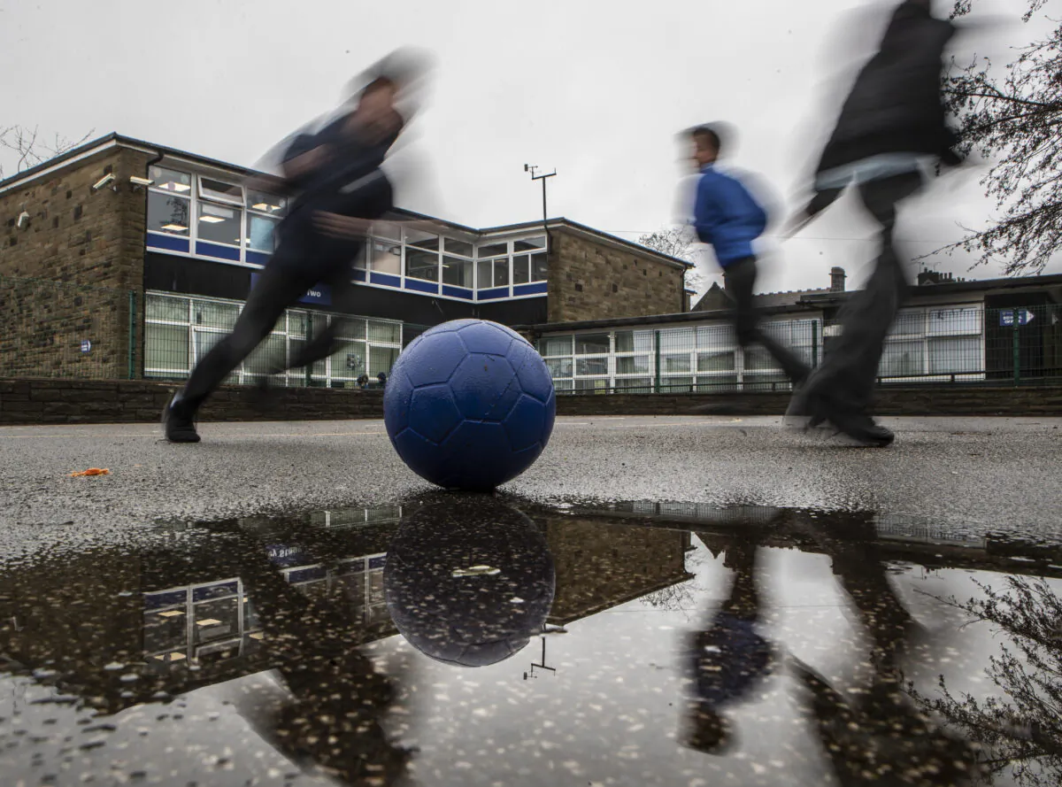 Students play on a playground at a school in the UK in a file photo. (Danny Lawson/PA)