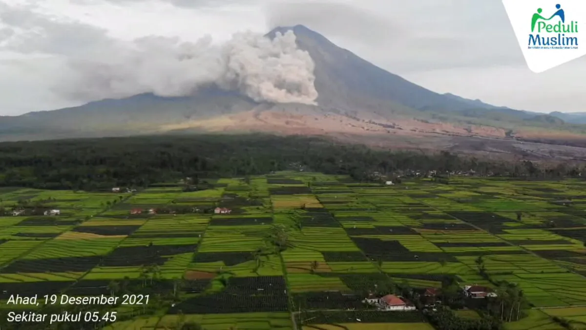 A drone view shows smoke and ash rising from side of Semeru volcano, in Lumajang, East Java, Indonesia, December 19, 2021, in this still frame obtained from social media video. Courtesy of Peduli Muslim/via REUTERS THIS IMAGE HAS BEEN SUPPLIED BY A THIRD PARTY. MANDATORY CREDIT. NO RESALES. NO ARCHIVES. MUST NOT OBSCURE LOGO