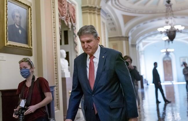 Sen. Joe Manchin, D-W.Va., a centrist Democrat vital to the fate of President Joe Biden's $3.5 government overhaul, walks to a caucus lunch at the Capitol in Washington, Dec. 17, 2021. (AP Photo/J. Scott Applewhite)