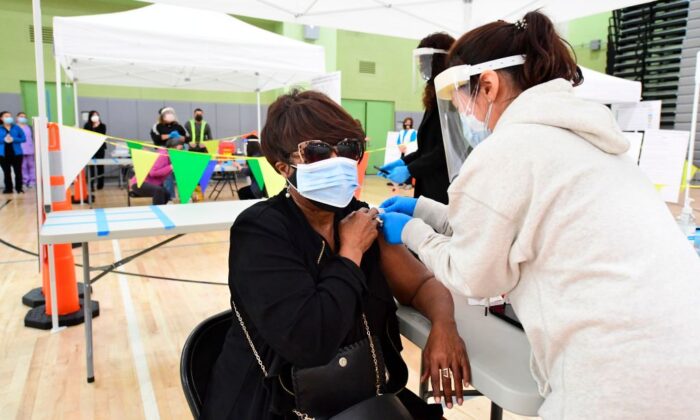 Carolyn Fowler of the Los Angeles Unified School District (LAUSD) receives her Covid-19 vaccination at a site opened by the LAUSD for its employees on February 17, 2021 in Los Angeles. (Frederic J. Brown/AFP via Getty Images)